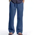 Detail of men's blue casual linen trousers featuring comfortable loose fit and adjustable drawstring. - S / Sapphire Blue