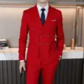 Details of the red double-breasted men suit, close-up view showing tailoring and fit in scene. - EU Size XXS / Red