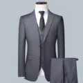 Detailed view of men's three-piece grey suit set with jacket, vest and trousers. - Dark Gray