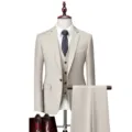 Men's 3-piece beige suit set featuring blazer, vest, and trousers on mannequin display. - US Size M / Top And Bottom / Beige