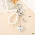 Elegant pearl chain bag charm with silver bow and heart pendants - Pearl Beaded Heart Style (K4534) / Pearl Bead Chain with Bow Heart Charm
