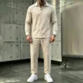 Detail view of men's casual linen V-neck long sleeve shirt and trousers set in beige. - Khaki