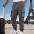 Detail view of men's casual fleece-lined cargo sweatpants in dark grey with pockets. - S / Dark Gray