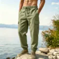 Outdoor scene showing details of casual olive green cargo pants with multiple pockets and drawstring. - S / Bottoms / Light Army Green