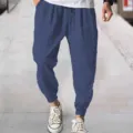 Detail view of casual blue men pants featuring comfortable cuffed hems and adjustable drawstring. - Dark Blue