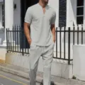 Outdoor detail view of men's grey waffle knit short-sleeve zip polo and pants set. - S / Top And Bottom / Gray