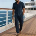 Men's casual linen short sleeve shirt and cargo pants set detail view on cruise deck. - Navy Blue