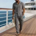 Detailed lifestyle shot of men's casual linen two piece set on cruise deck, showing outfit drape. - Gray