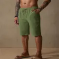 Detail shot of men's casual cotton linen shorts with drawstring waist and deep pockets. - Army Green