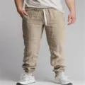 Detail view of men's casual linen drawstring jogger pants, featuring comfortable fabric and cuffed hems. - S / Bottoms / Khaki