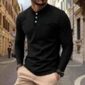 Close-up detail of mens black waffle long sleeve Henley shirt with chest pocket design. - S / Black