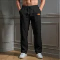 Detail view of men's casual loose trousers featuring a comfortable drawstring waist and side pockets. - S / Bottoms / Black
