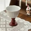 Detail shot of a retro ceramic dessert cup with a wooden base, elegant table setting. - White Tulip Pattern / 14x11.5cm