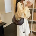 Dark brown leather shoulder bag, trendy hobo dumpling crossbody bag with stylish strap. - Coffee