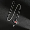 Macro view of a gothic silver cross pendant with a brilliant red gemstone detail - Red Rhinestone Wreath Cross