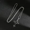 Macro view of gothic punk cross necklace with black gemstone and vintage silver chain - Black Rhinestone Wreath Cross