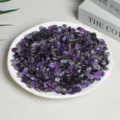 Polished natural amethyst crystal chips displayed on a white plate for home decor - 3-5mm/500g / Amethyst