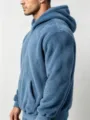 Side view of men's blue plush fleece hoodie showing cozy texture, hood, and front pocket. - Blue