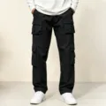 Detailed view of men's black multi-pocket cargo pants, casual loose fit twill trousers for outdoor. - S / Black
