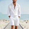 Close-up detail of the men white linen shirt and shorts set worn on a beach boardwalk. - S / Top And Bottom / White