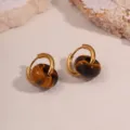 Close-up of gold hoop earrings with brown tiger eye stone beads on a sandy background. - Brown Tiger Eye Style (NX109)