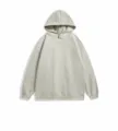 Vue détaillée du sweat-shirt à capuche décontracté avec grande poche avant et texture douce. - Vert clair