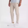 Close-up detail of men's slim-fit casual trousers in khaki with elastic stretch fabric. - Apricot