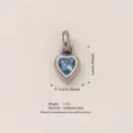Detailed macro view of a heart-shaped stainless steel pendant with blue crystal - March Birthstone / Pendant Only (No Chain) / Steel Color/Sky Blue