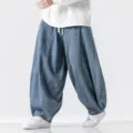 Détails du pantalon harem en denim ample, avec jambes larges, taille à cordon et coupe décontractée. - M / Bas / Bleu clair