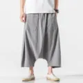 Detailed view of men loose dropped crotch harem pants in grey, casual summer cropped style. - M / Gray