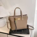 Large capacity canvas tote bag for women, stylish commuter shoulder bag with tennis pendant. - Brown