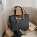 Black textured large capacity tote bag with handles and shoulder strap, stylish commuting bag. - Black