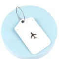 White PU leather luggage tag with metal wire ring and cute airplane travel pattern for suitcases. - White