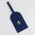 Etichetta per bagagli in pelle blu con aereo dorato, porta badge da viaggio resistente. - Blu navy