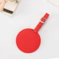 Red round PU leather luggage tag with embossed smiley face design and metal buckle. - 8.5cm / Red