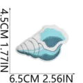 Close-up detail of blue and white seashell embroidered patch, fine stitching craftsmanship. - C32HL-076-29