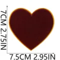 Red heart embroidered patch close-up detail shot showing fine stitching and yellow border. - X27SD-11-27