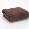Soft brown cotton bath towel with chic chevron woven pattern, highly absorbent and durable. - Coffee