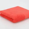 Einfarbiges reines Baumwolltuch weich saugfaehig korallenrot rechteckig gefaltet Badetuch - 34x75cm / Orangerot