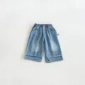 Close-up detail of cute kids denim wide-leg pants showing heart embroidery and raw frayed hems. - 73cm / Blue