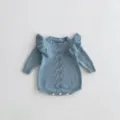 Close-up detail of the cute light blue knitted baby romper showcasing ruffle shoulders and knit. - 66cm / Grey Blue