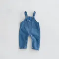 Infant denim overalls detail shot, classic blue baby jumpsuit with front pocket and snap buttons. - 73cm / Blue