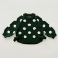 Detailed view of dark green knit toddler sweater with white polka dots and cute side bows. - 66cm / Green