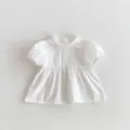Cute white baby girl short sleeve blouse with sweet ruffles and pleated front details. - White