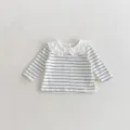 Detailed view of baby striped long-sleeve t-shirt with cute white ruffled doll collar. - 66cm / Black Stripe