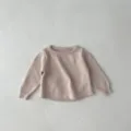 Close-up details of baby knit sweater, soft cotton fabric texture, comfortable round neck. - 73cm / Apricot Top
