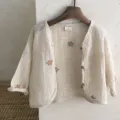 Detailed view of baby minimalist beige floral embroidered cardigan with wooden buttons. - 73cm / Flower Style