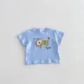 Close-up detail view of the adorable cartoon lion applique and print design on the infant t-shirt top. - 66cm / Blue