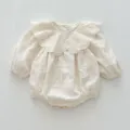 Detailed view of baby vintage embroidered long sleeve romper with delicate floral ruffled collar. - 66cm / Apricot Rompers