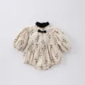 Detailed view of baby girl floral romper, vintage black bow collar, soft fabric design. - 66cm / Short Romper